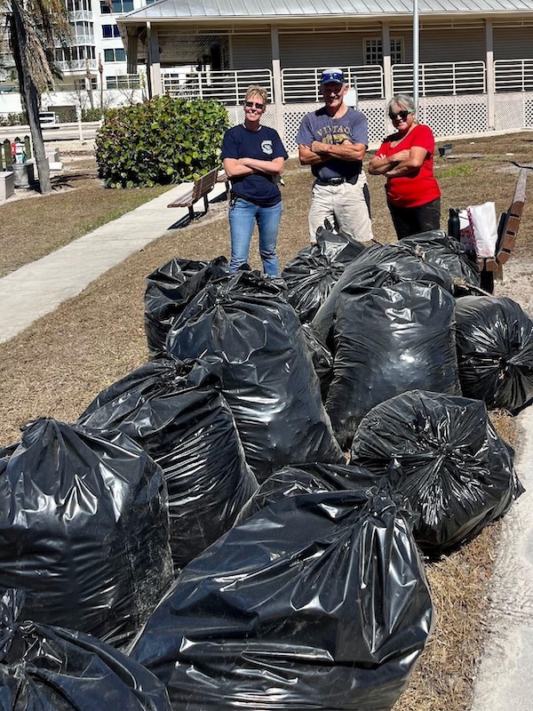 Bonita Springs, Florida – Auxiliarists (L to R) Ellen DeLeo, Terry Schwinghammer, and Heidi LaQuadra pose proudly with some of the 28 bags they packed with hurricane debris outside the Wiggins Pass Flotilla meeting place on Oct. 22, 2022. Photo By: Auxiliarist Anthony Lorenc.